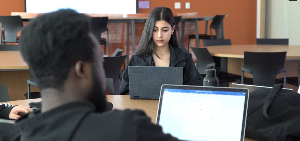 screen capture of a moment in the video of students studying with their laptops