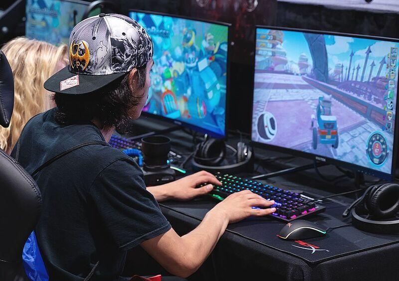 A student sitting at a computer playing a game