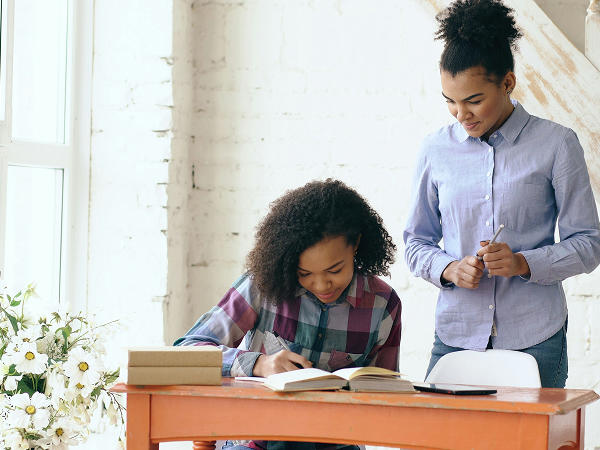 A mom and daughter doing homework together