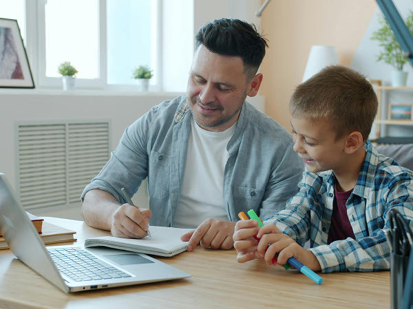 A dad and son doing homework