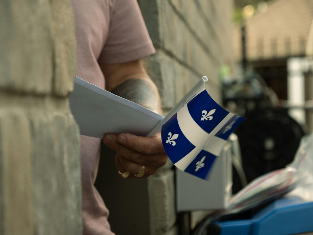 Man holding Quebec flag