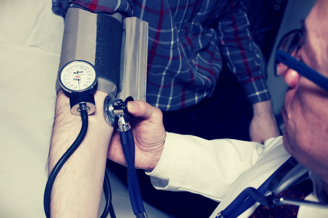 Doctor measuring blood pressure of patient