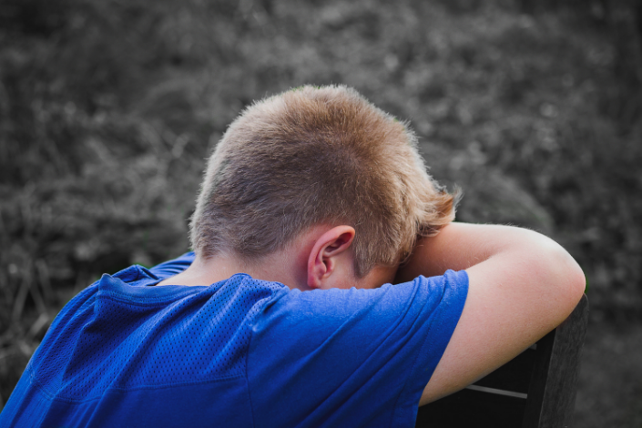 Young boy expressing sadness