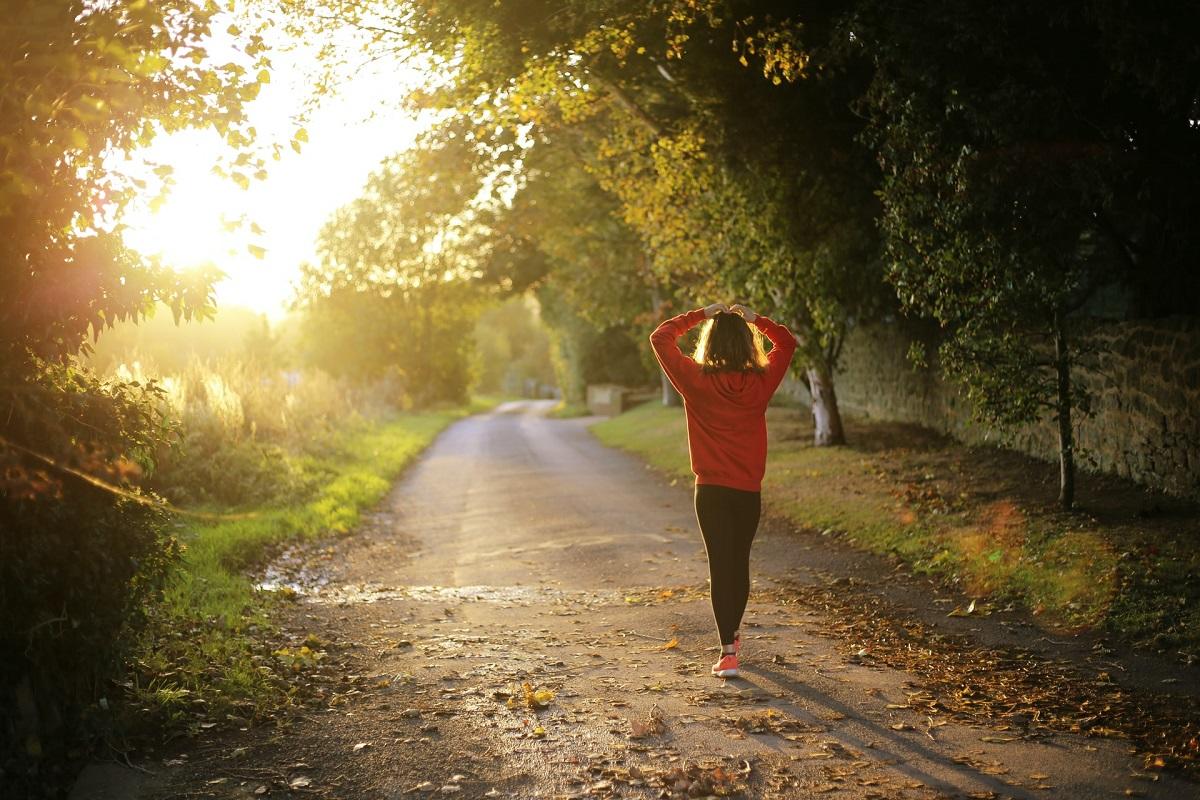 Woman walking along path in nature