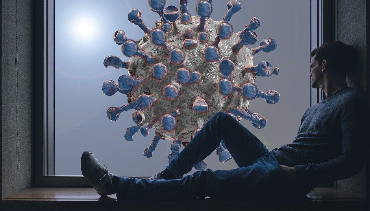 Man peering out window at large coronavirus