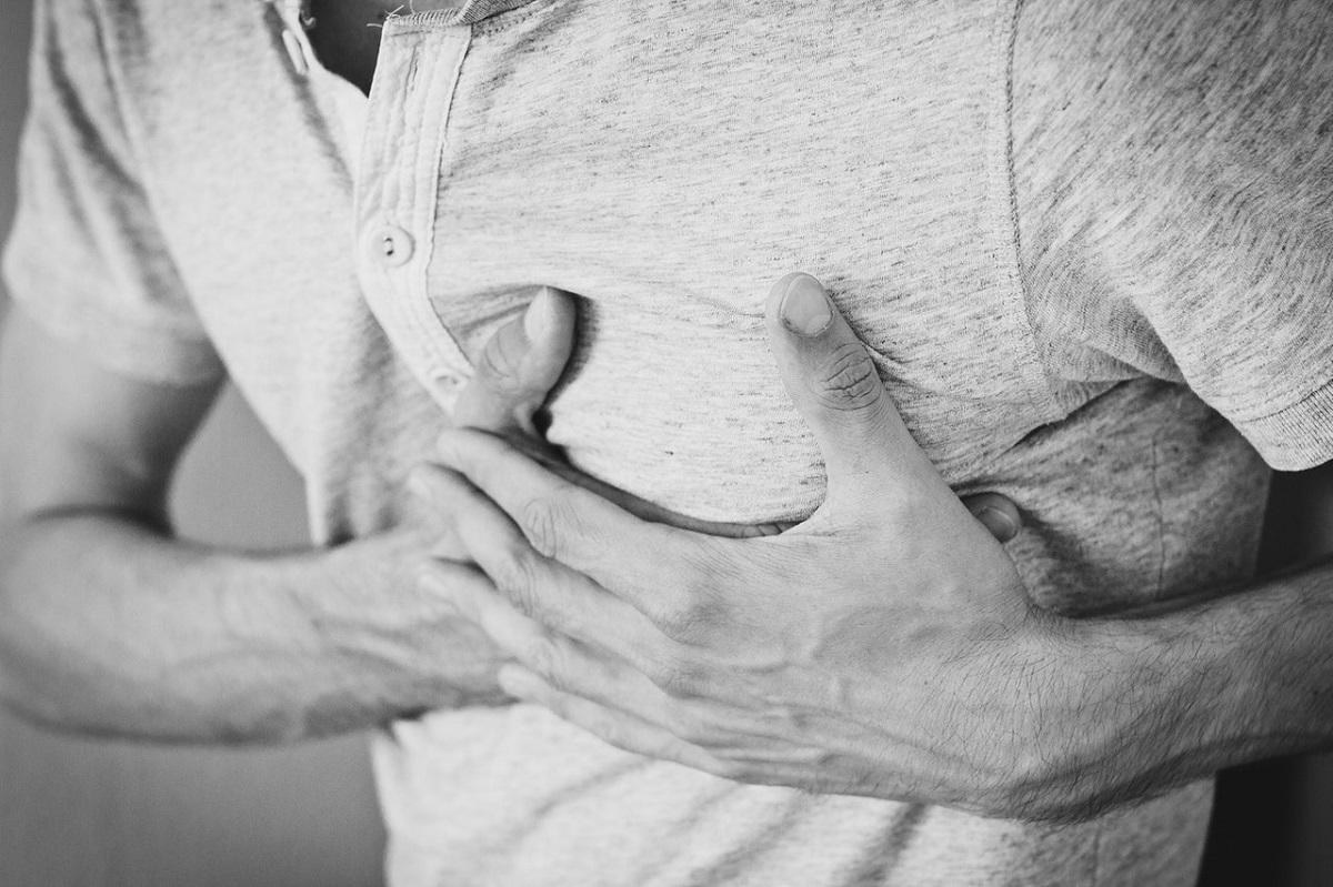 Hands clutching chest