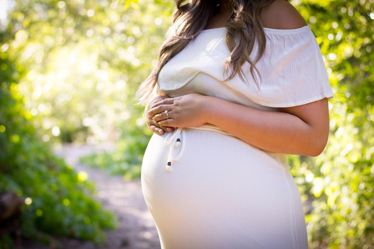 Pregnant woman with hands on belly