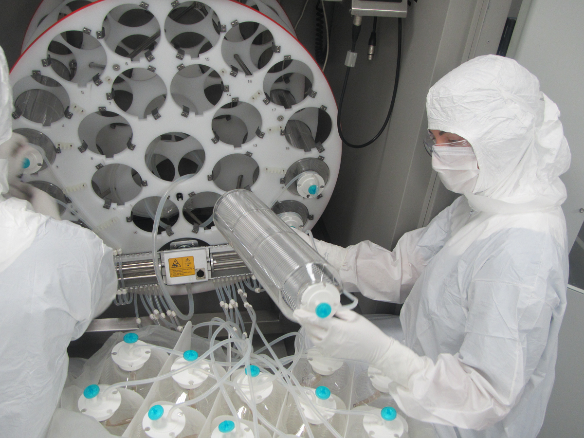 Lab technician in PPE handling samples