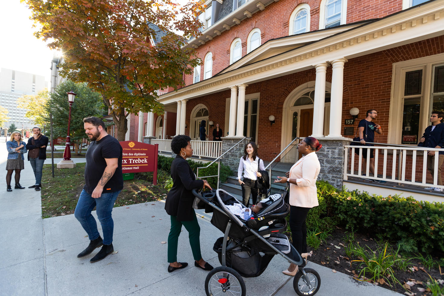 Group of alumni socializing outside of the Alex Trebek alumni hall.