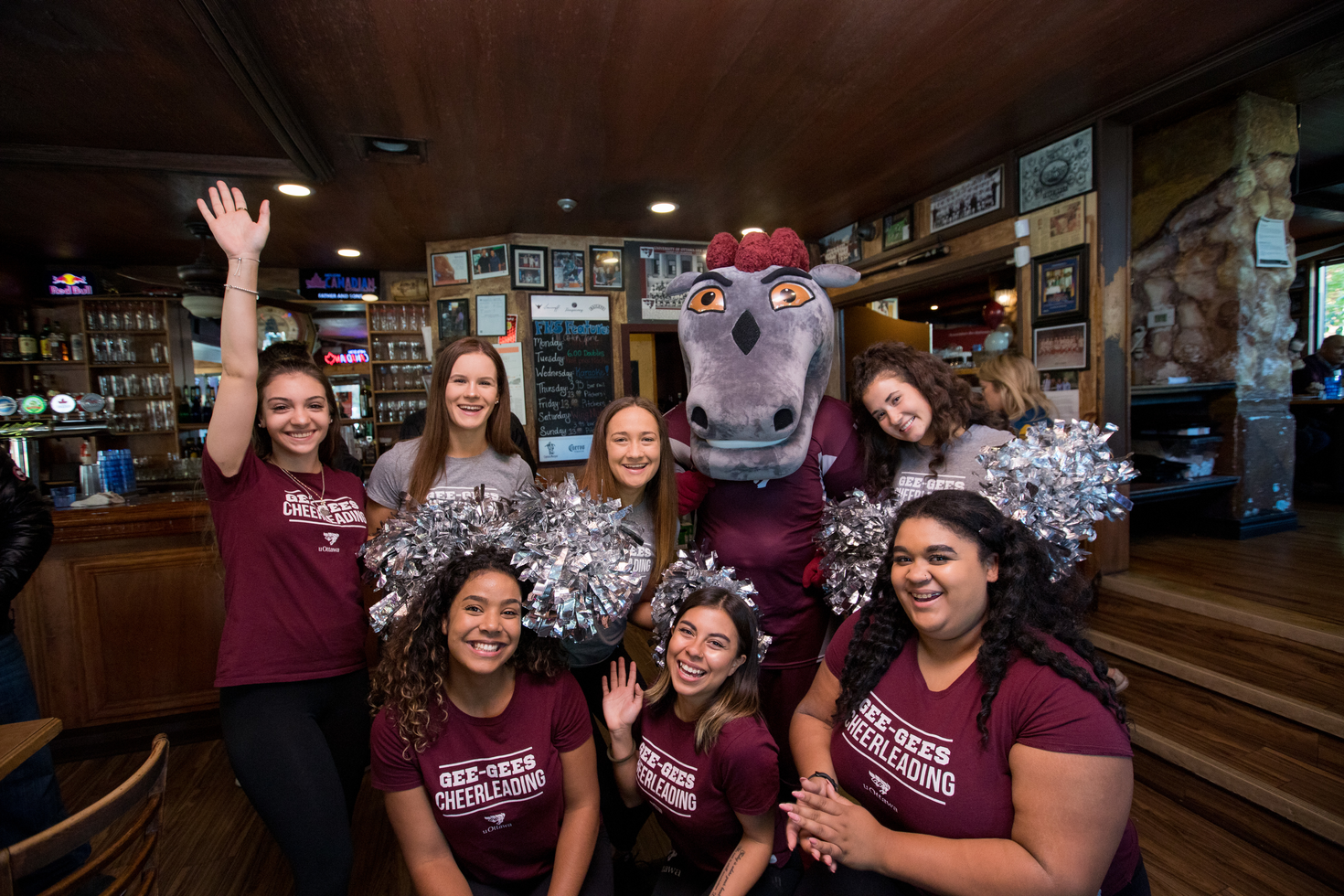 girls posing with mascot