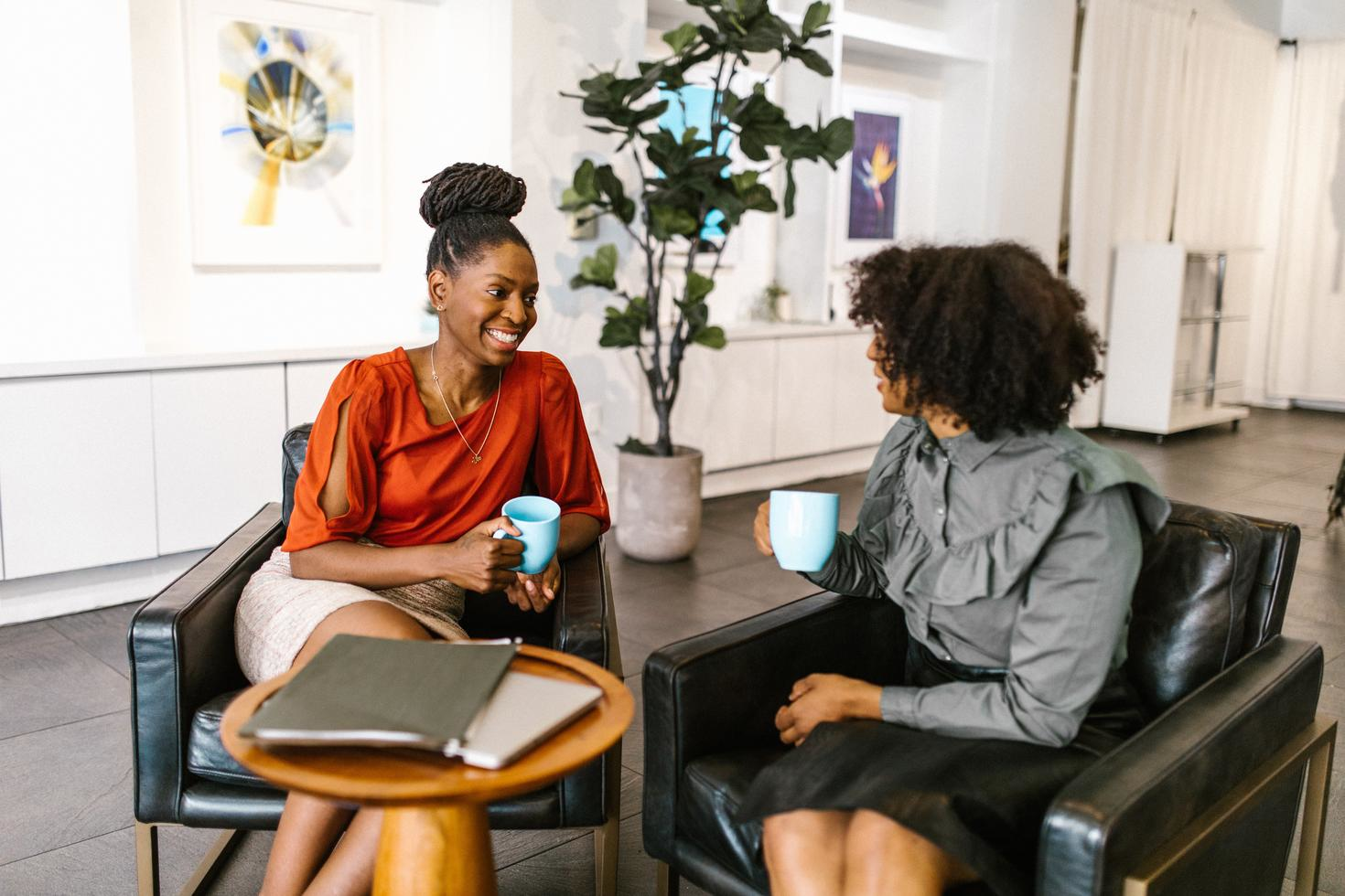 Two people chatting over a coffee.