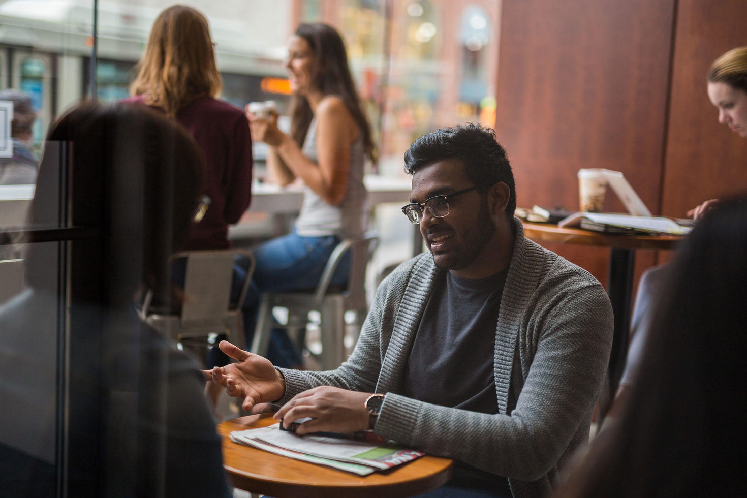 Two people conversing at a table.
