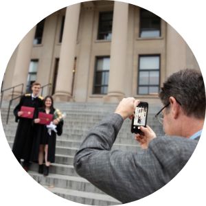 Father taking a photo of his children on convocation day.