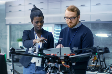 Two people looking at a machine