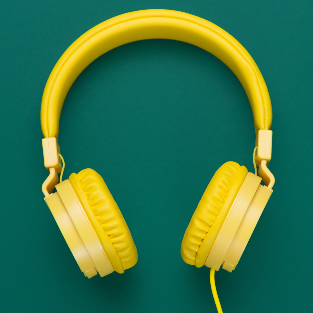 A pair of headphones against a green background