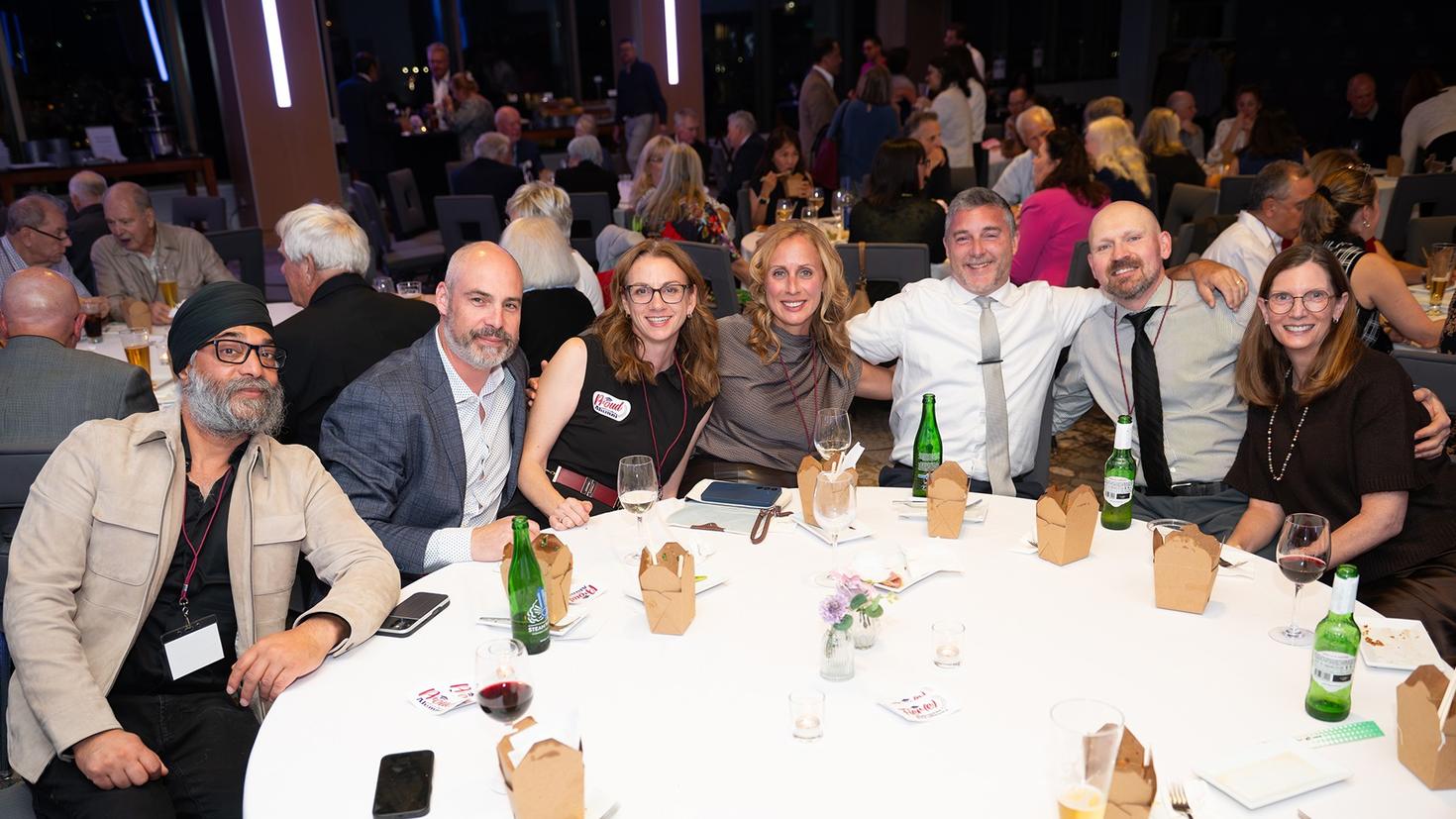 Guests seated around a table at the Homecoming 2026 welcome reception.