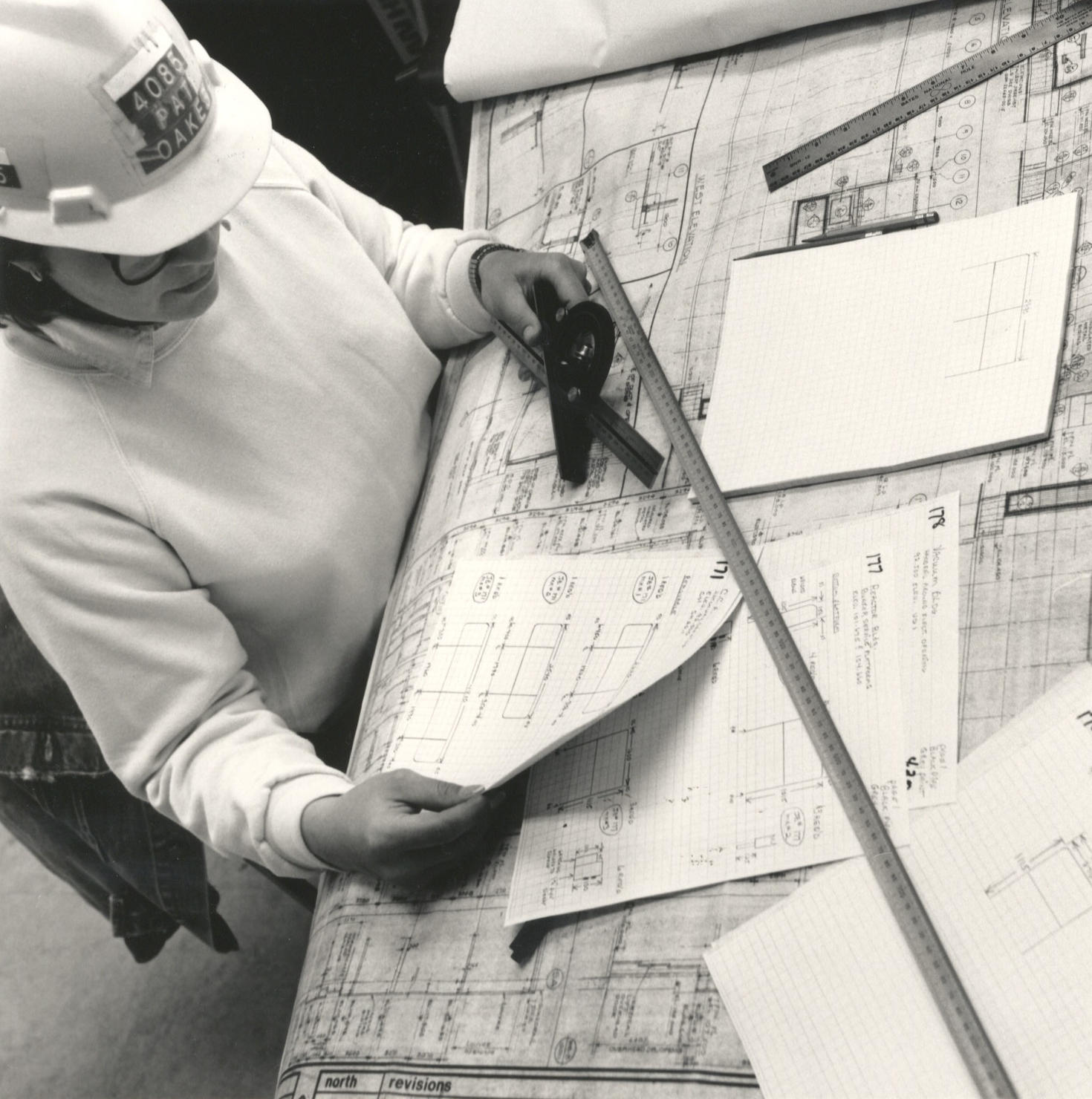 Femme travaille sur des plans d'architecture