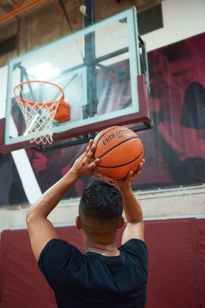 Men shooting at a basketball net..