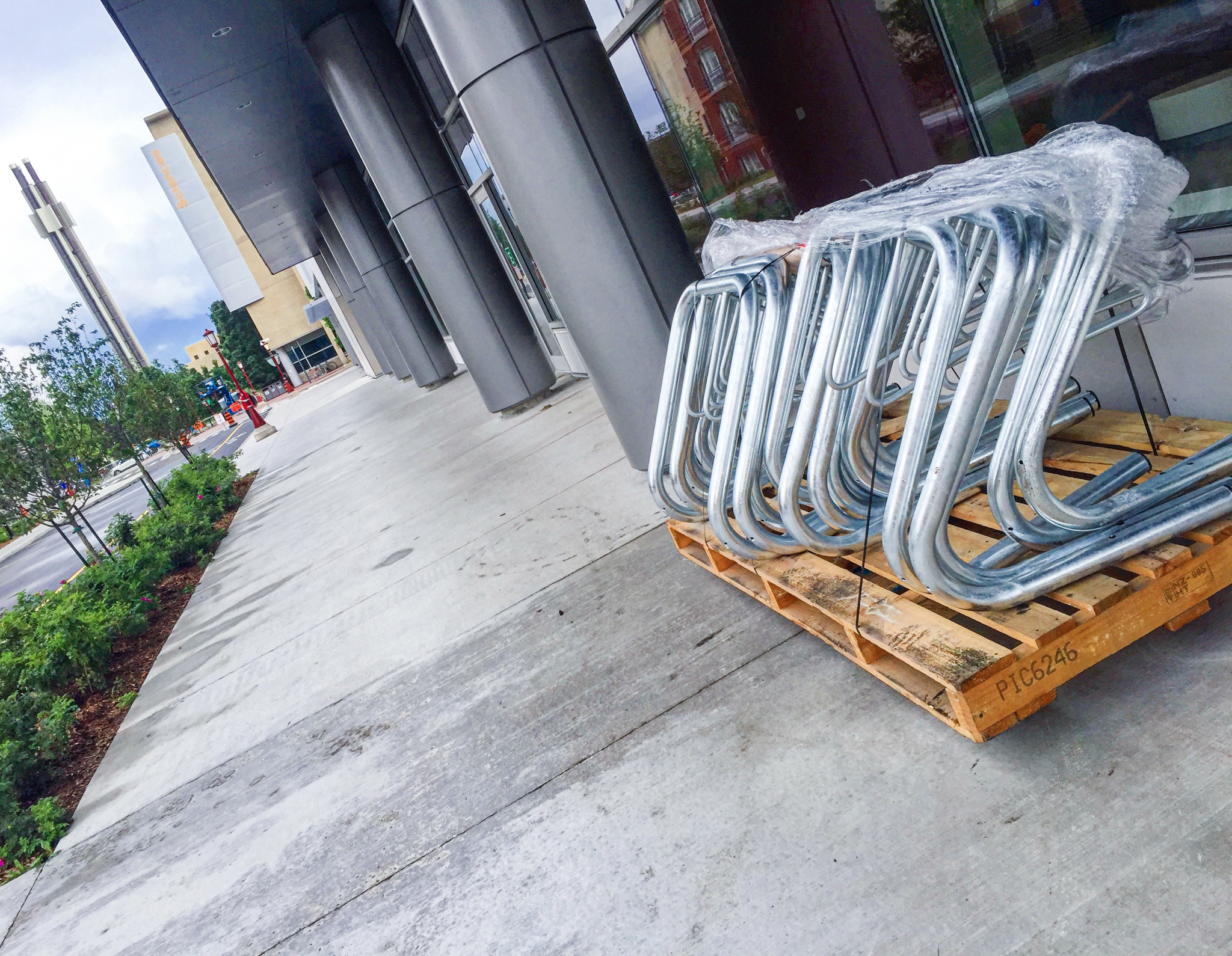 a bunch of bike racks ready to be installed in front of the STEM building at the University of Ottawa