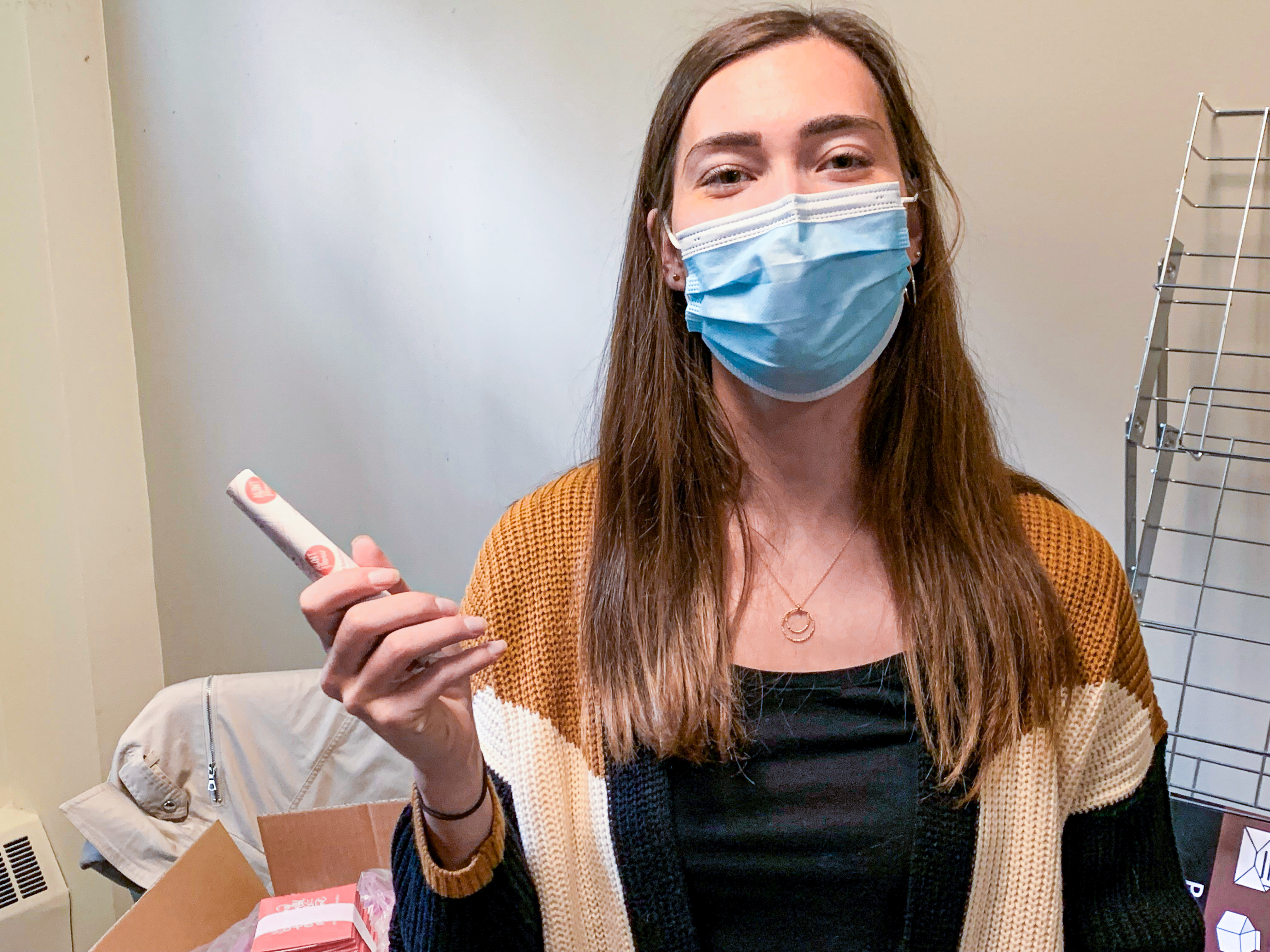 A person holds up a sample menstrual product