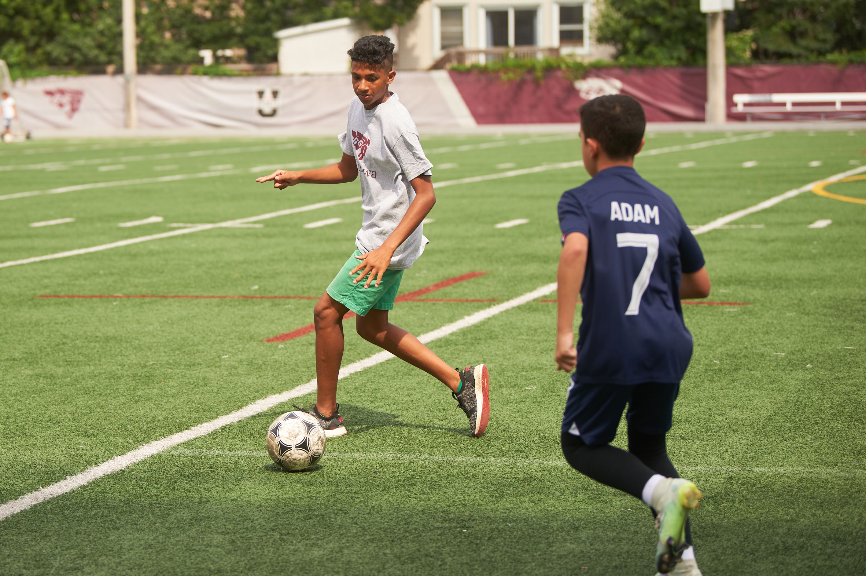 child at camp playing soccer