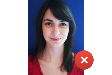 unacceptable photo for student card showing girl looking at camera but on blue background