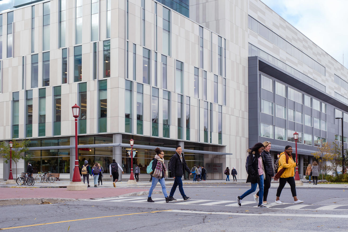 Students walking across street in groups.