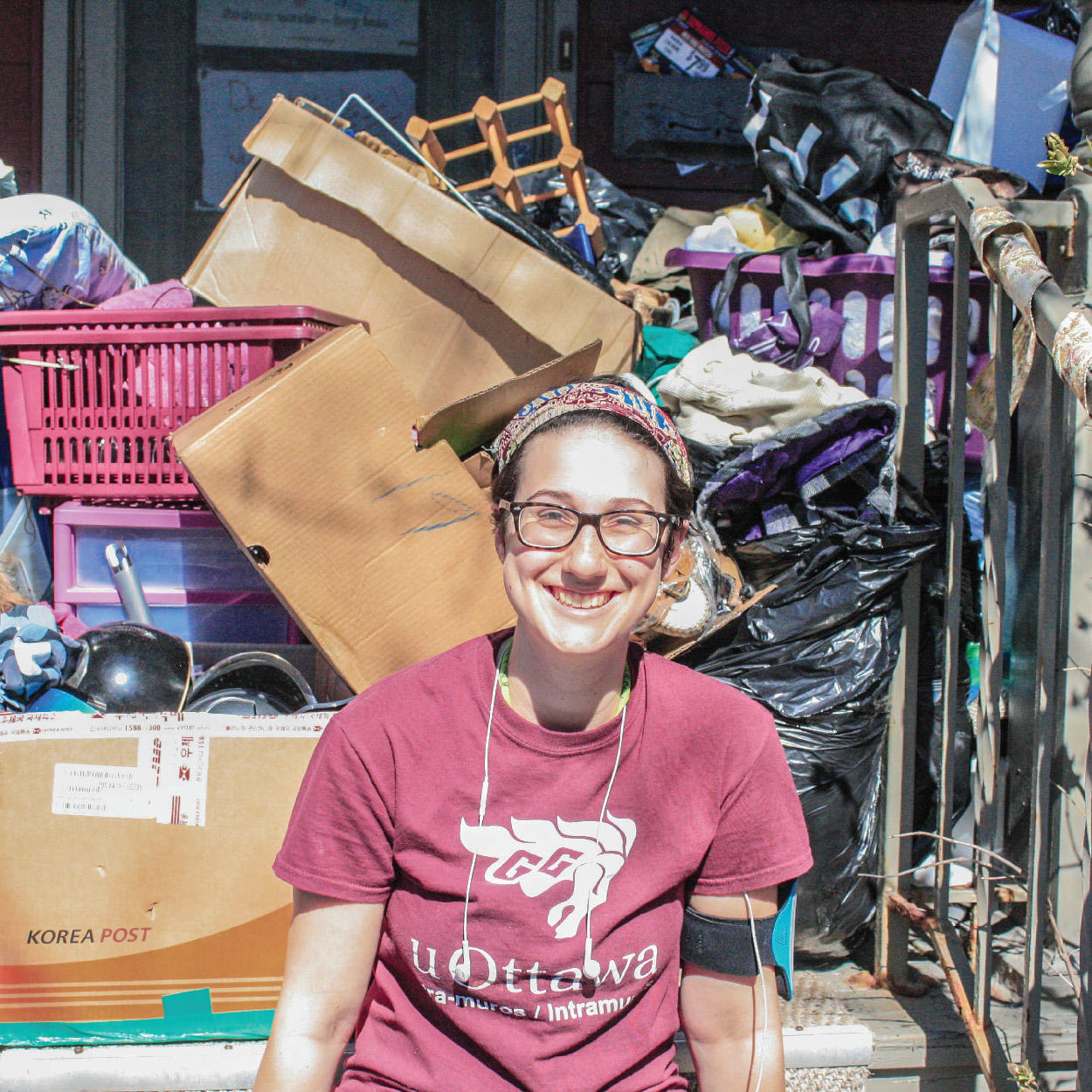 A person attending the Dump and Run with a pile of donations behind them