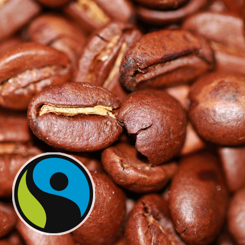Coffee beans with Fair Trade logo in the forefront bottom left corner