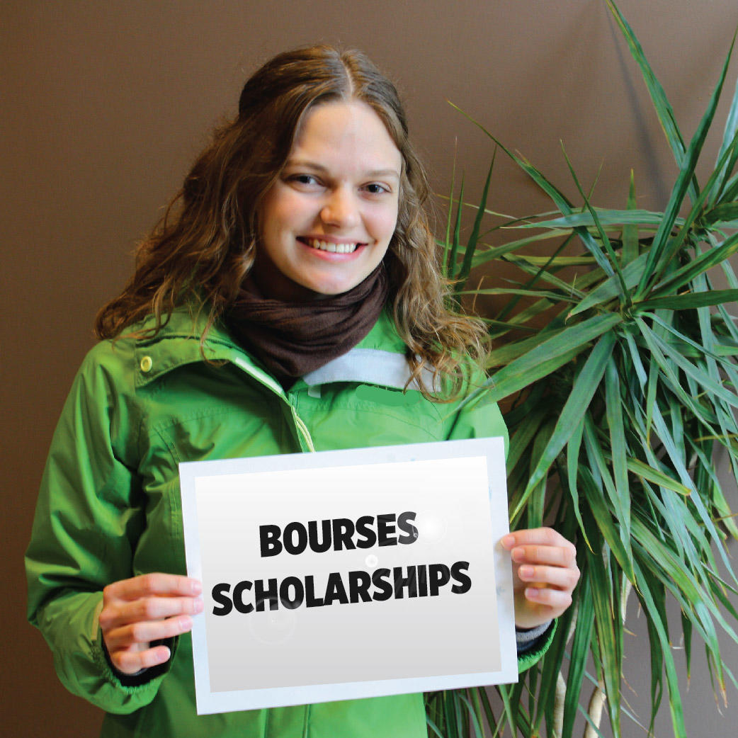 Student holding a paper with Bourses Scholarships written on it