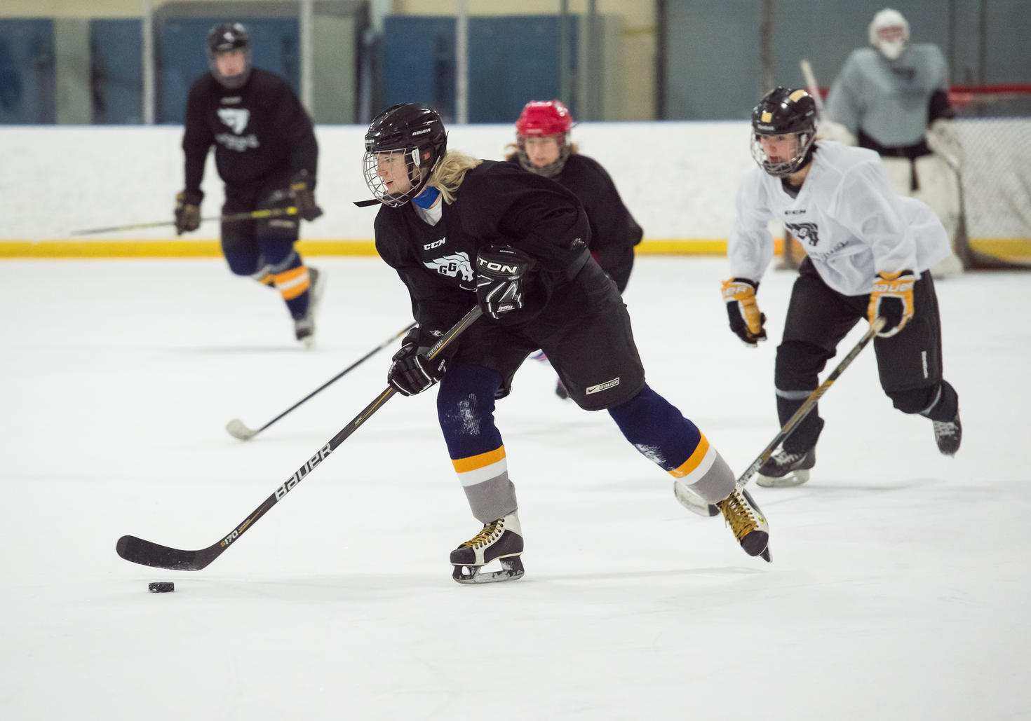 Person playing hockey on the ice.