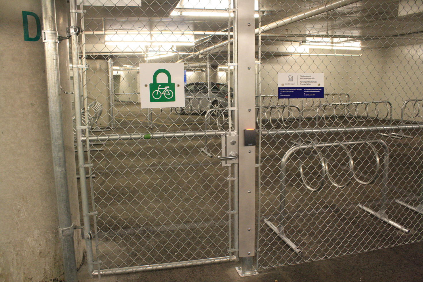 Indoor bike racks behind a secure fence in the Desmarais building at uOttawa