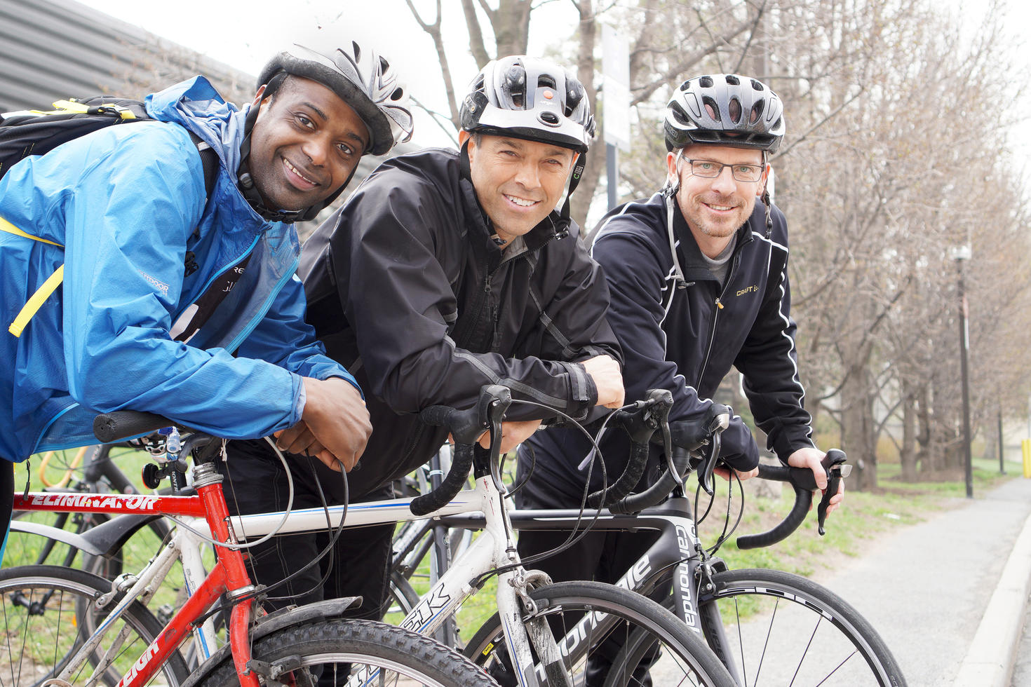 Three uOttawa employees resting by their bikes