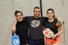 three young individuals ready to play pickleball