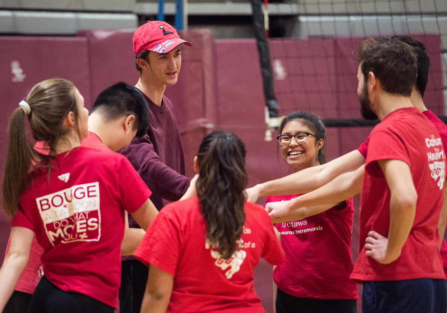 group of students joining hands