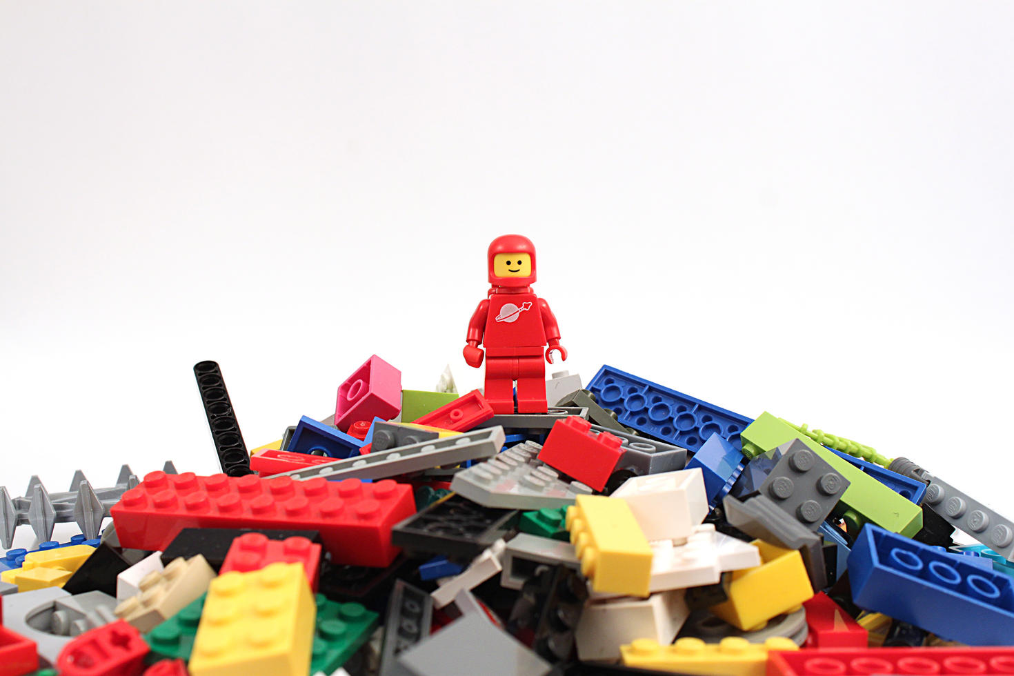 LEGO figuring standing atop a pile of LEGO pieces
