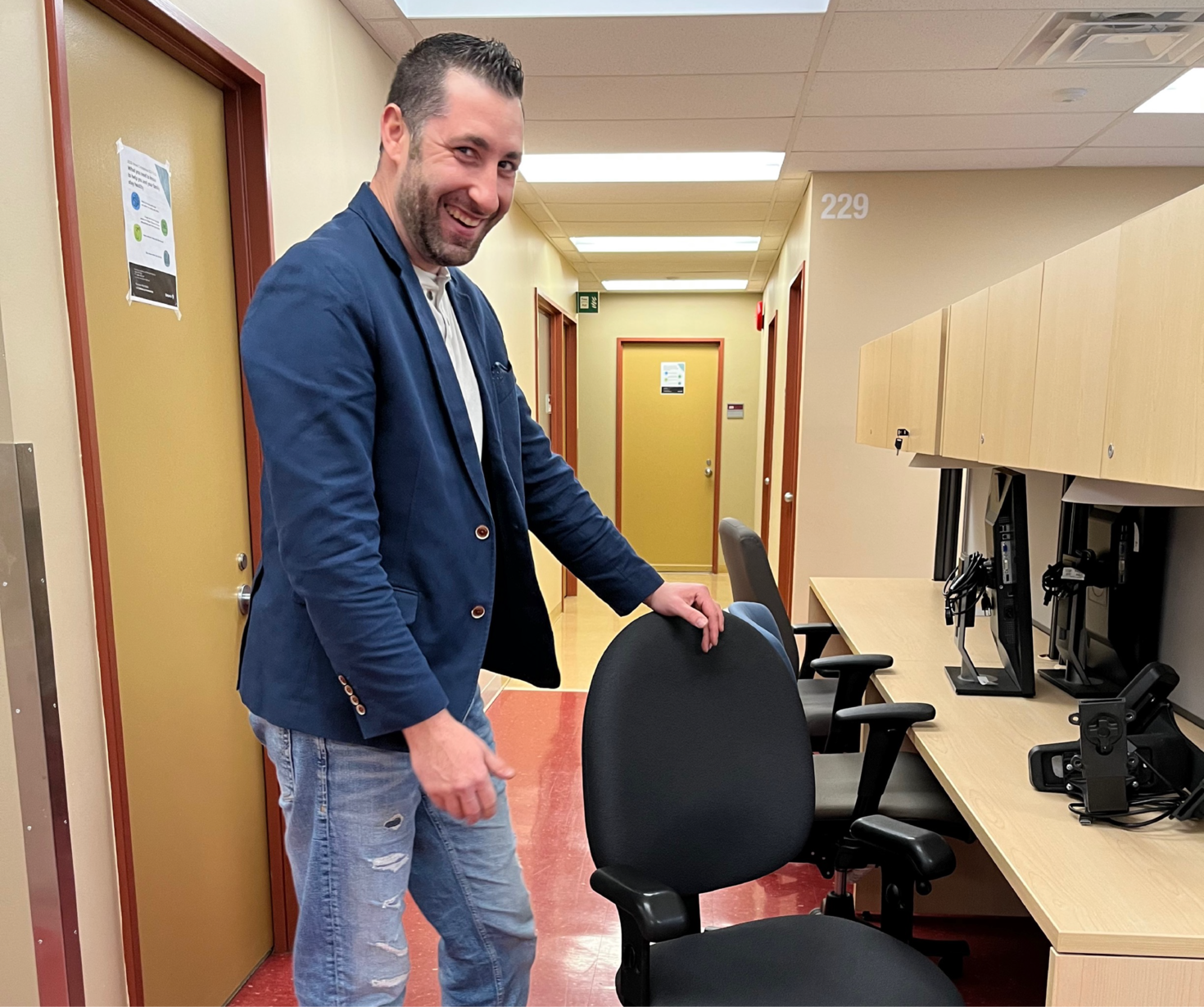 An employee poses with a chair