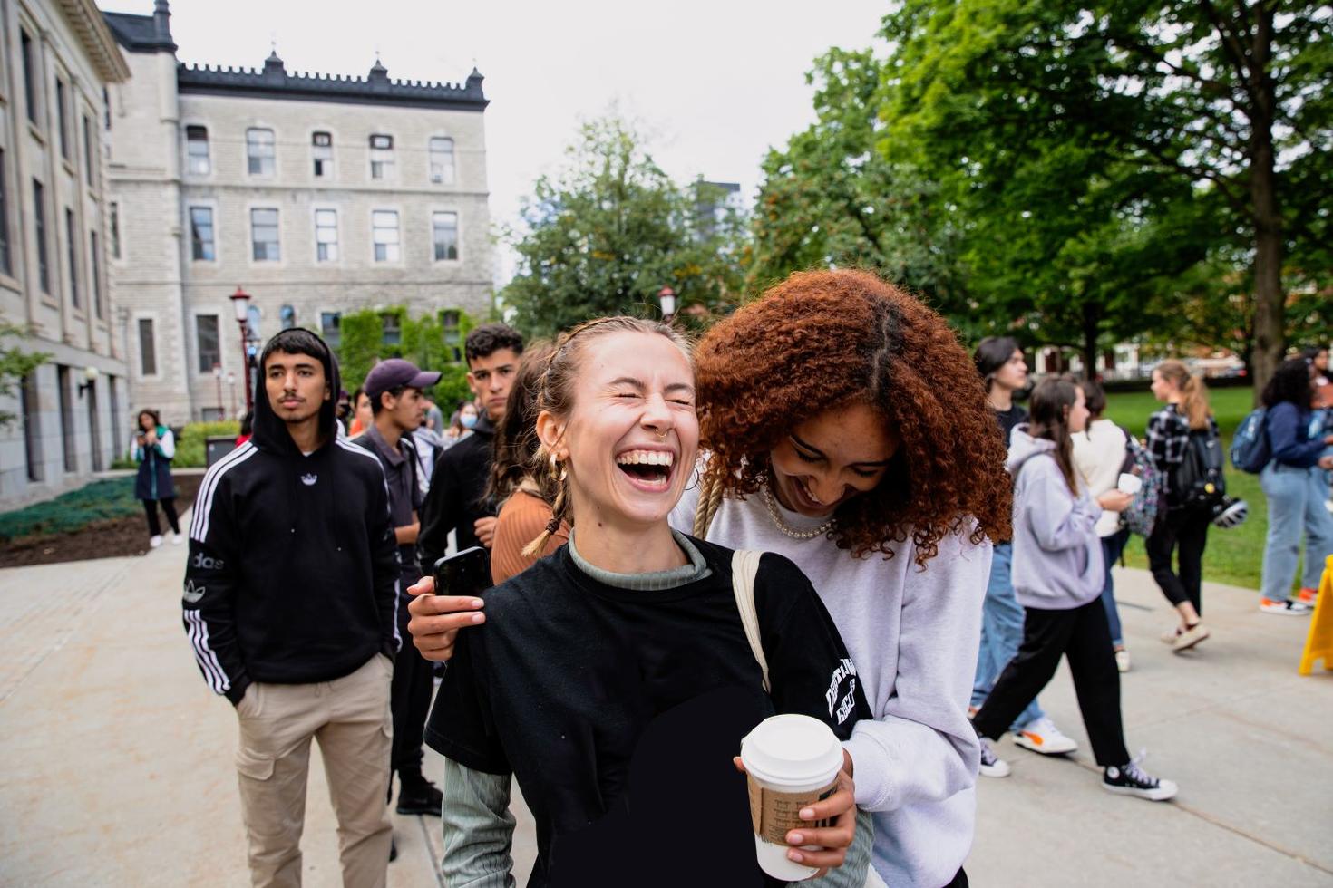 students laughing and walking outside