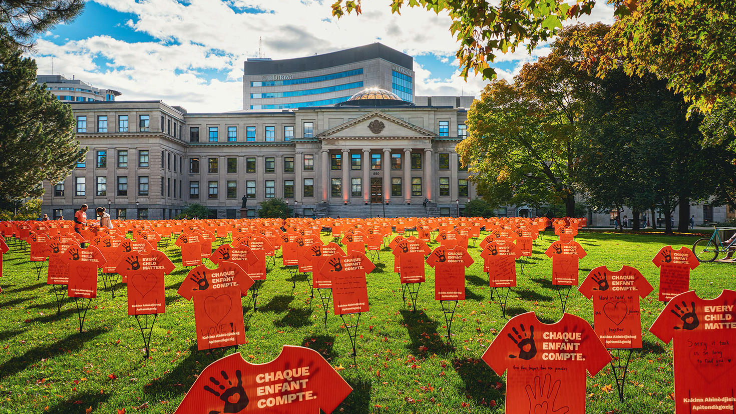 Orange t-shirts filling the lawn outside of Tabaret Hall.