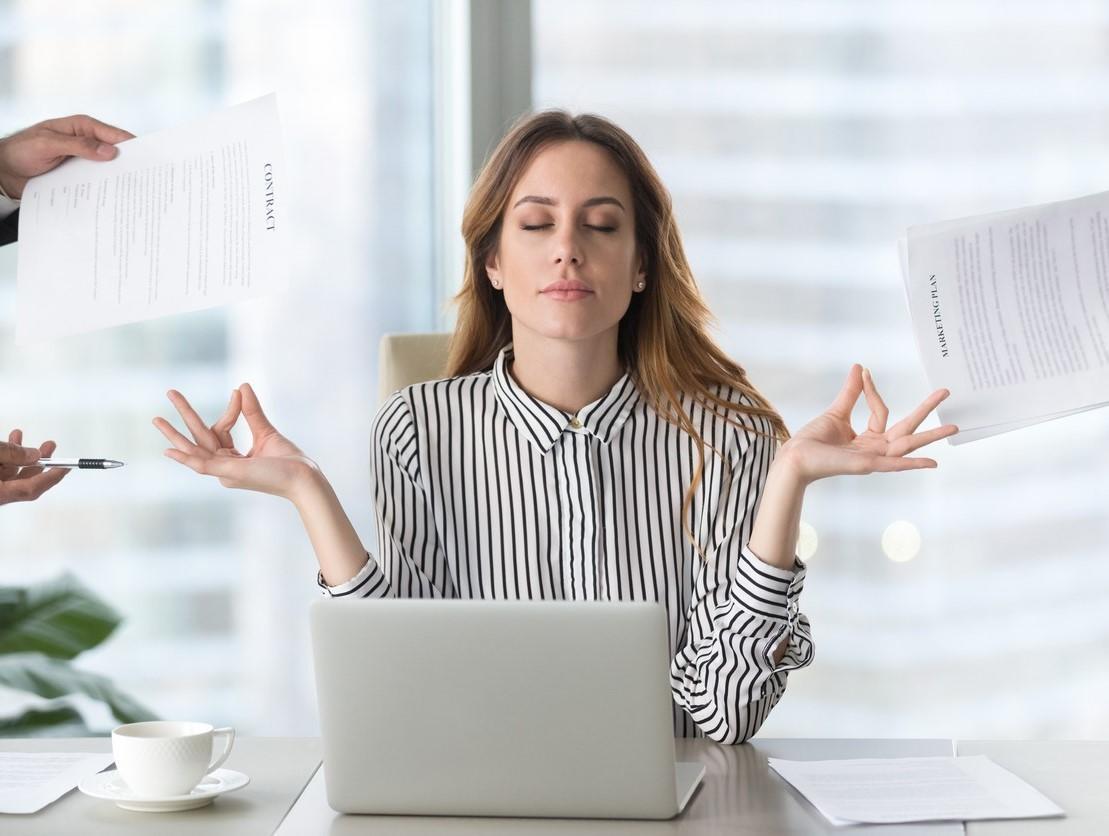 person trying to look calm and relaxed sitting behind a laptop