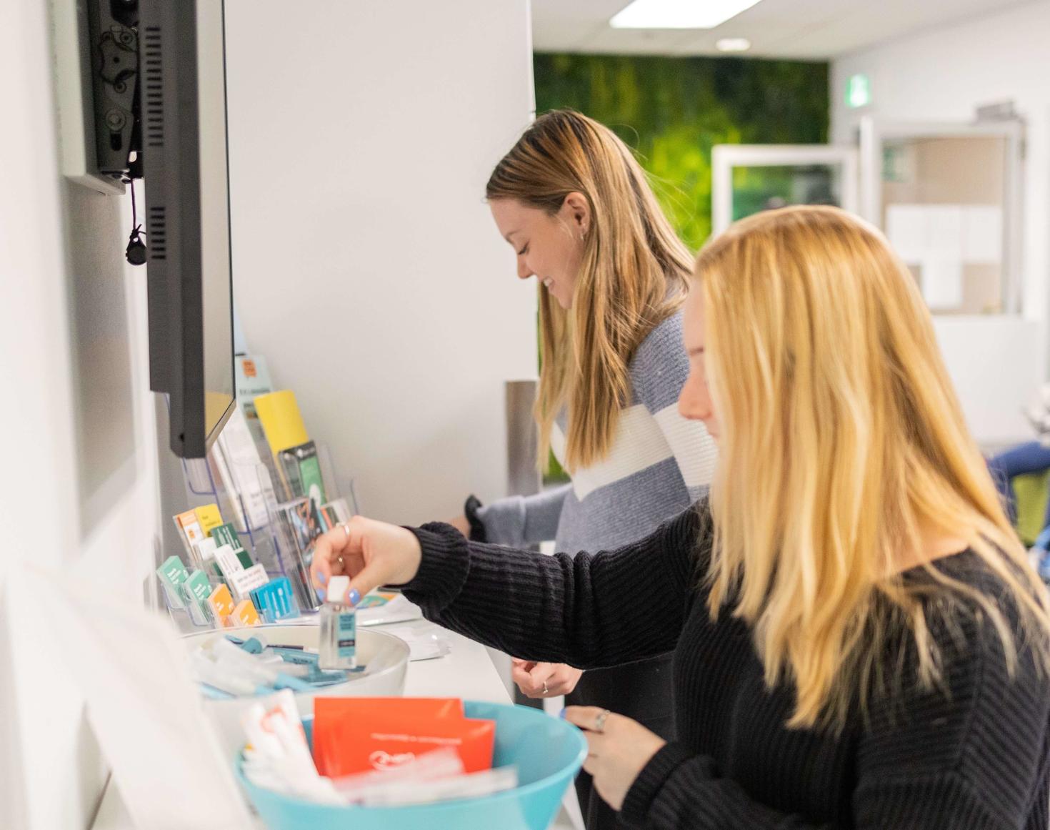 Students looking through resources and snacks at the Student Health and Wellness Centre