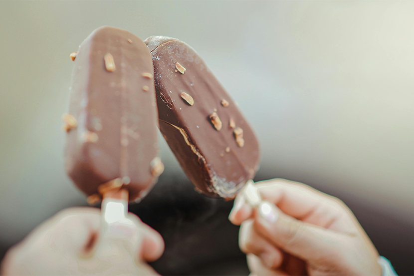 Hands holding ice cream bars