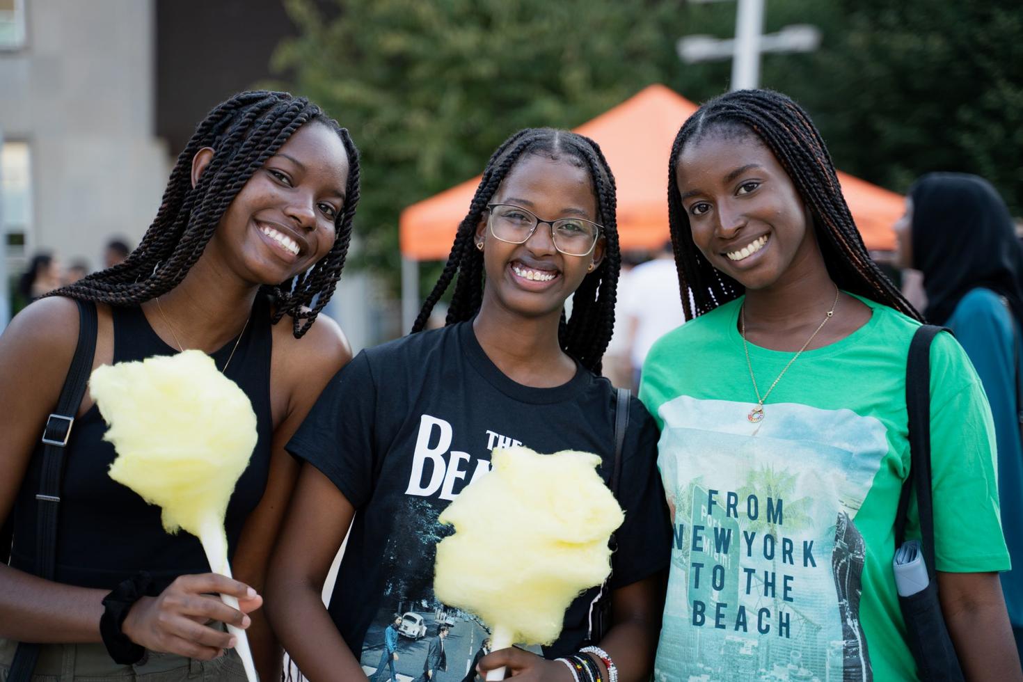 Three new student-friends enjoying some cotton candy on campus.