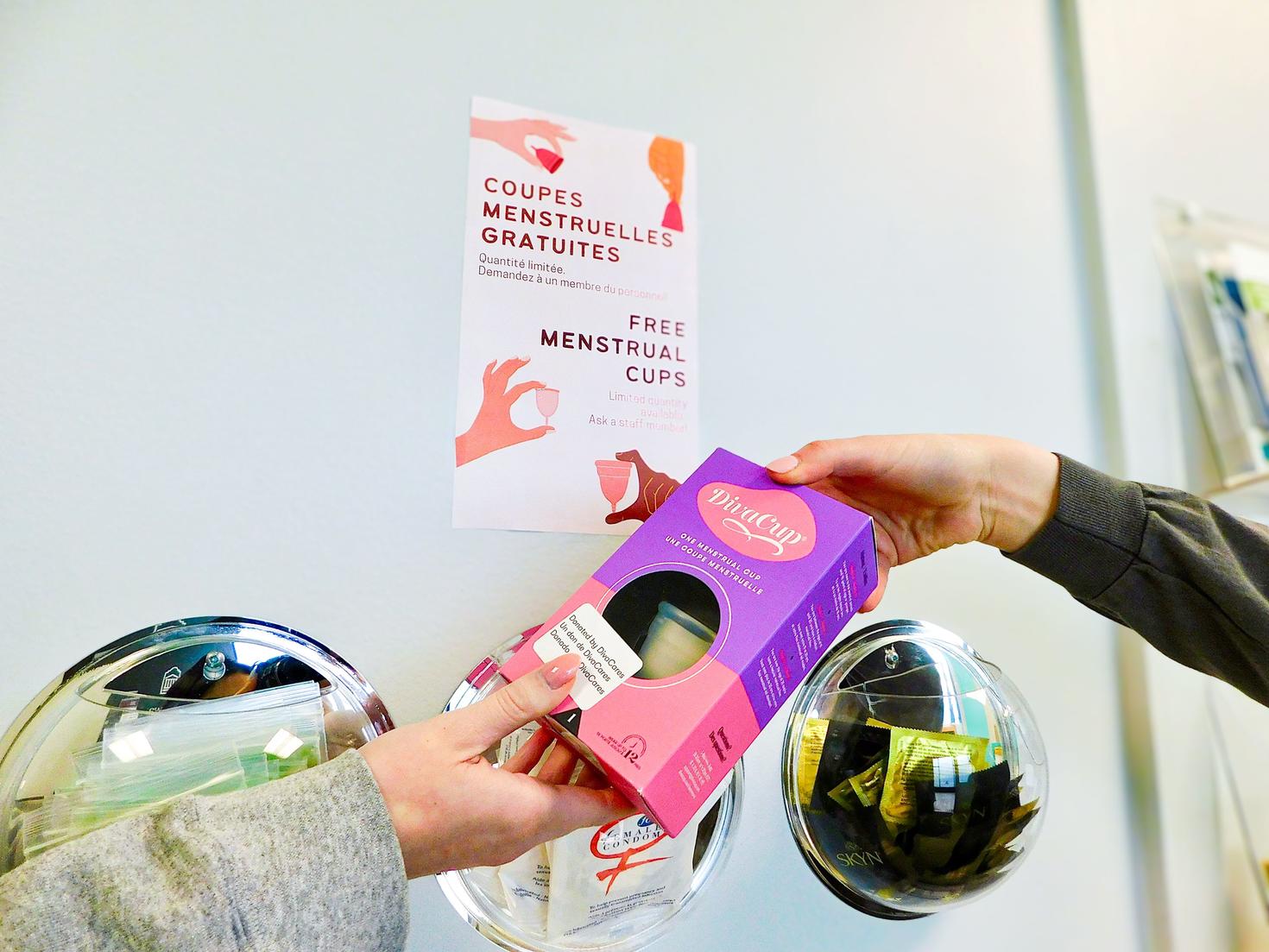 A student passing along a menstrual cup to another student