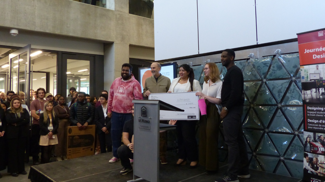 Competition winners accepting a check on stage 