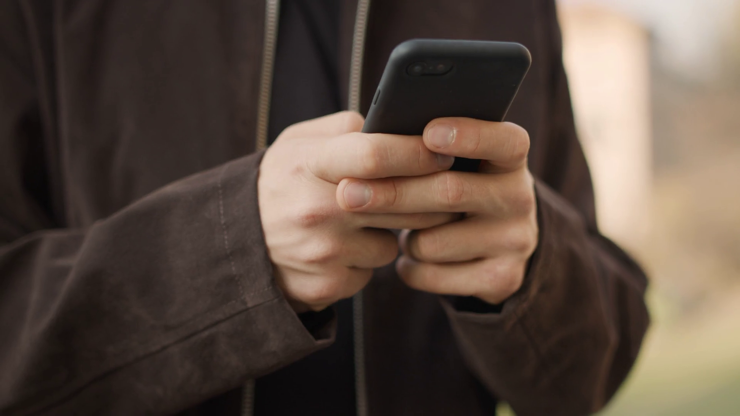 Closeup on man hands texting 