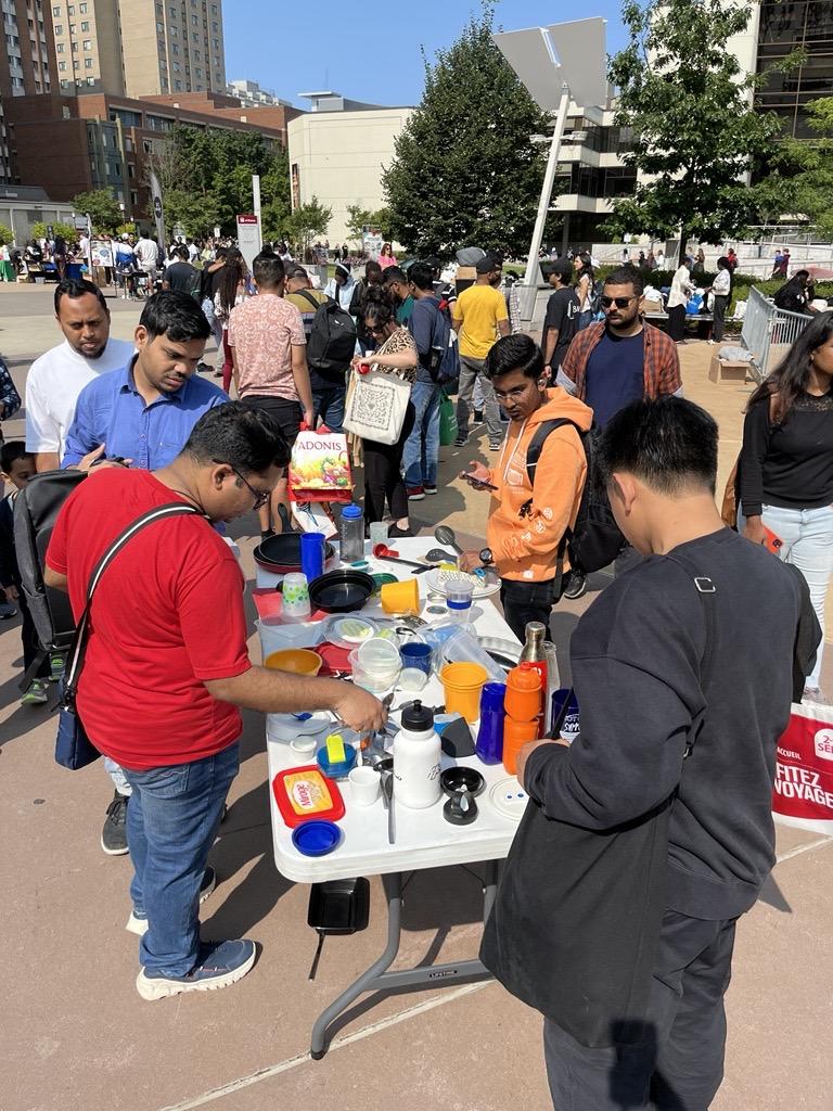 students crowd around items at a Free Store pop-up event