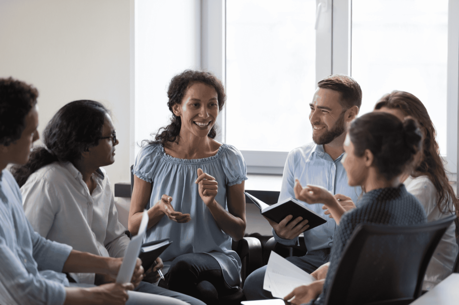 Group of people talking together in a warm setting.