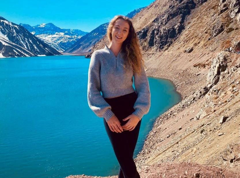 Marianne Stinzi standing in front of mountains in Chile. 