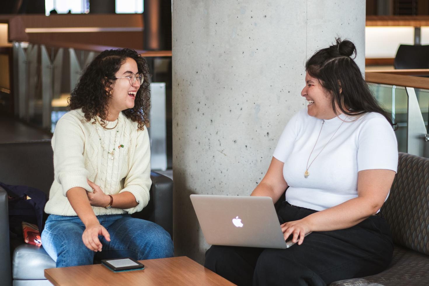 Two students are laughing as they study together at the University of Ottawa.